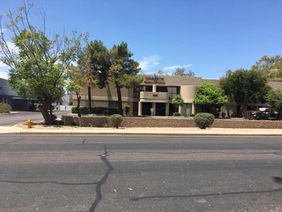 An office building on the corner of a street.